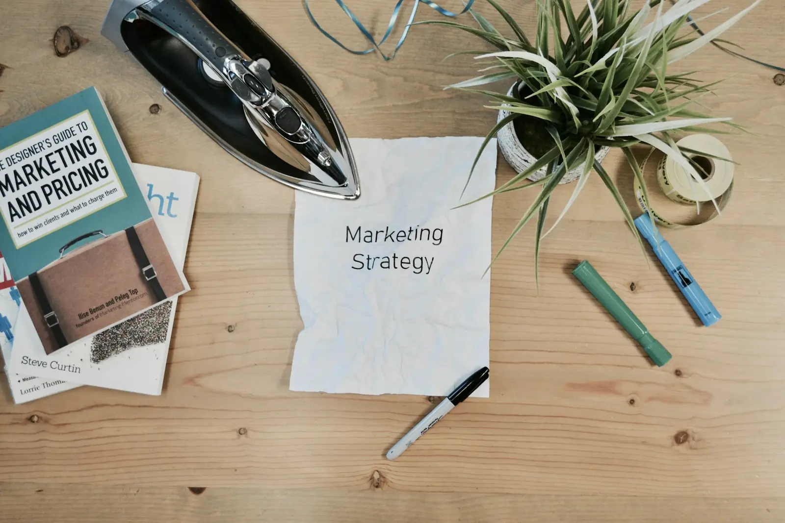 Marketing strategy notes and books on a wooden desk