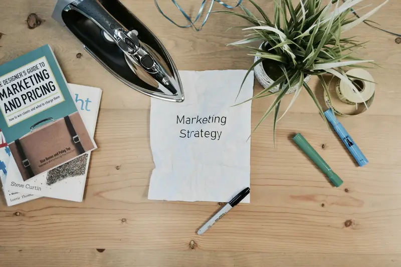 Marketing strategy notes and books on a wooden desk